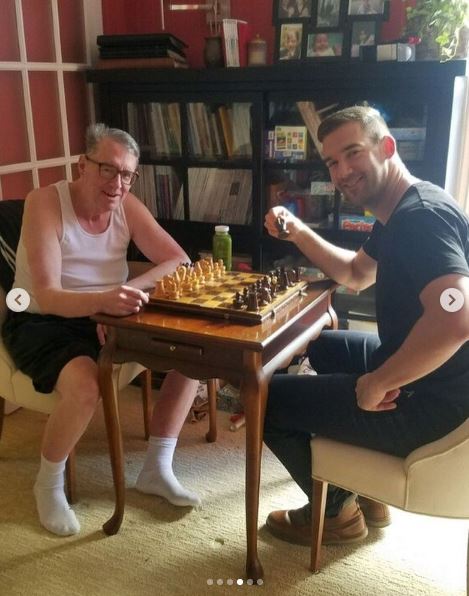 Lewis Howes plays chess with his father.