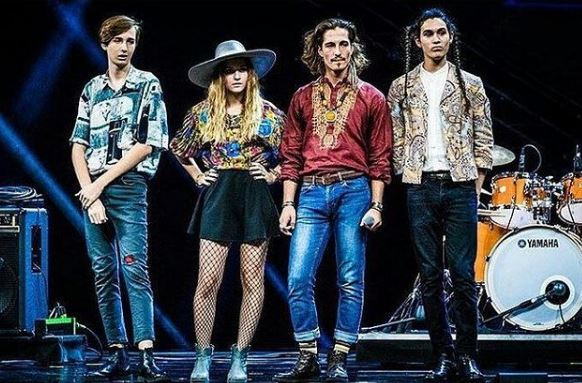 Ethan Torchio and Måneskin's band members on the stage of The X Factor