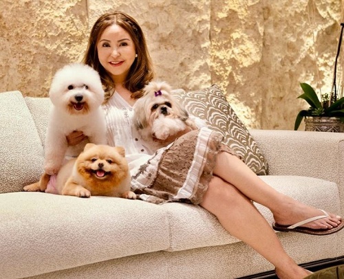 Small Laude with her pet dogs
