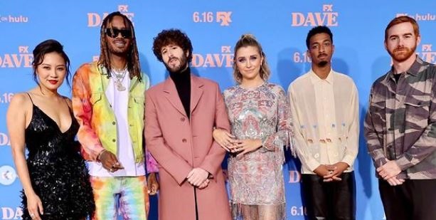 Taylor Misiak photographed with the cast of Dave