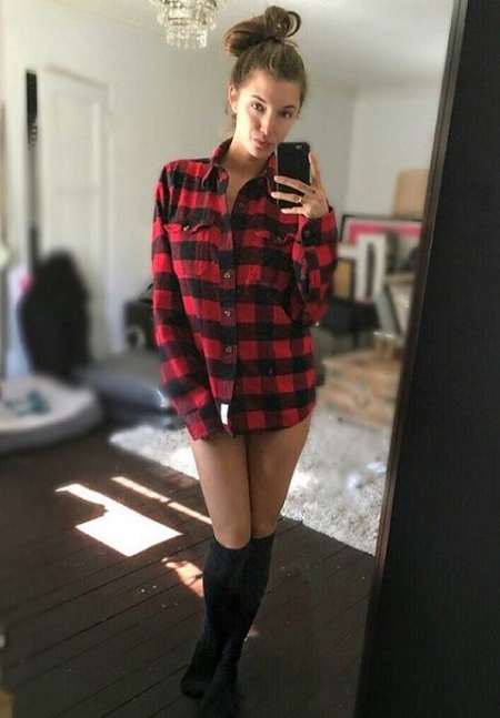 Alyssa Arce posing in front of mirror in her Los Angeles home