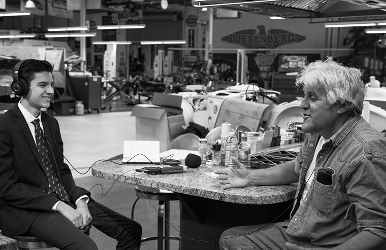 An old photo of Adam Faze at Jay Leno's podcast A Leg Up
