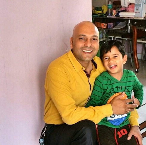 Harshvardhan Jain with his son at his home