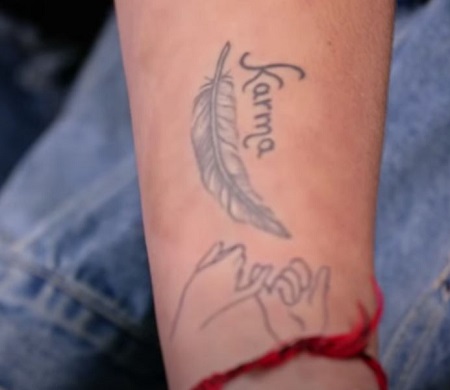 Jenefer Riili has a Karma tattoo