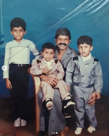 Old image of John Kokken with his father and siblings