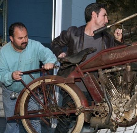 Frank Fritz and Mike Wolfe transporting an old Indian bike