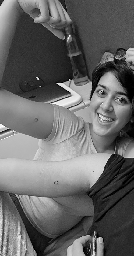 Moose Jattana's twinning circle tattoo on her bicep with a boy