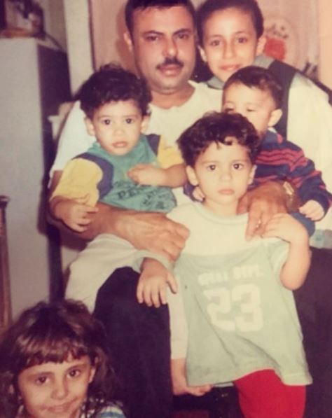 Old image of Adam Saleh with his father & siblings