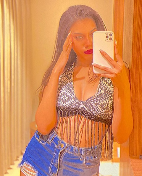 Simran Khan taking a filtered selfie with her iPhone 12