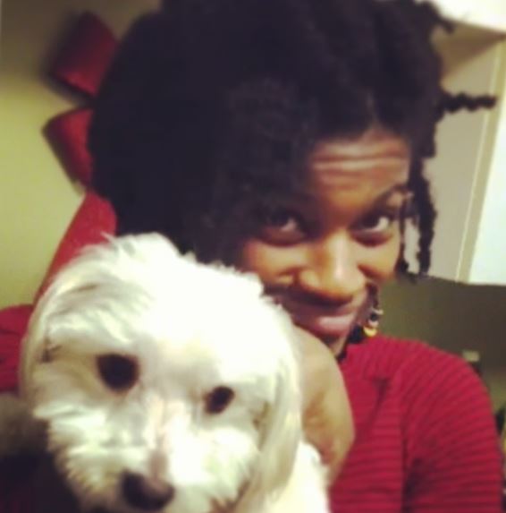 An old photo of Ashley Romans with her pet dog
