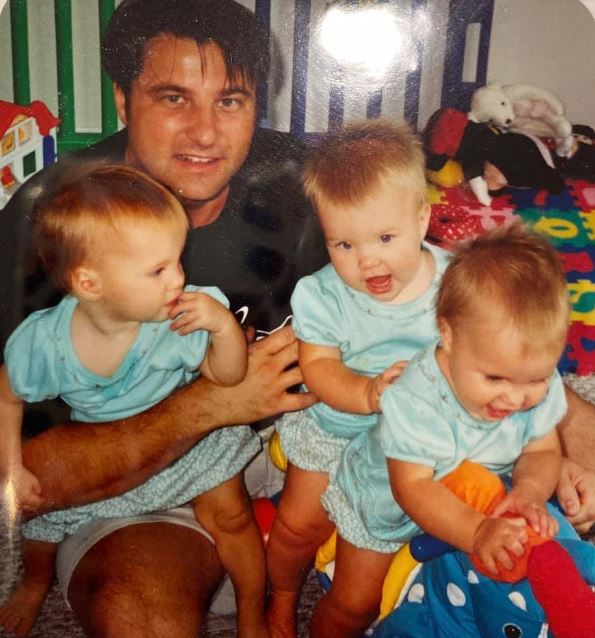 Childhood image of Sophie Scott with her father and sisters
