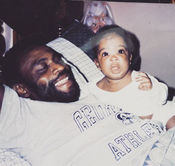 Childhood photo of Ashley Romans with her father