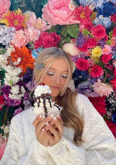 Emily Dobson posing with her favorite dessert