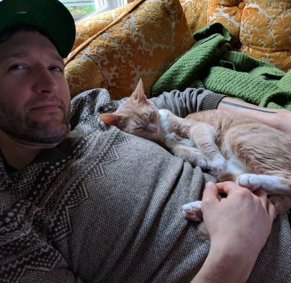 Christopher Robinson with his pet cat Screams