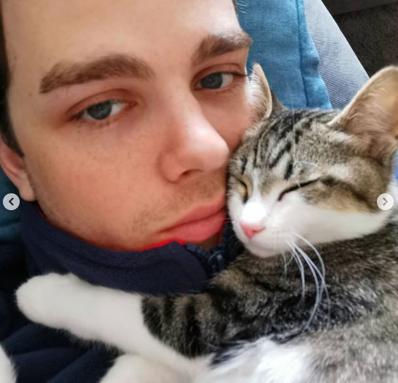 Joshua with his pet cat Achilles