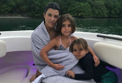 Reign Disick with his mother and sister