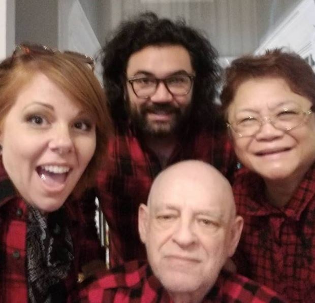 Omstead with his dad Larry Omstead, mom Imelda Omstead, and wife Que Omstead