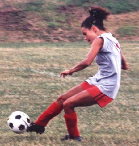 Joy Taylor in her teenage playing football
