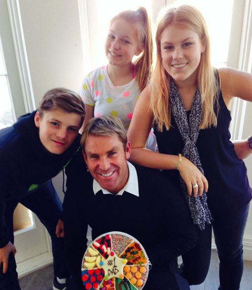 Jackson Warne with his father and sisters