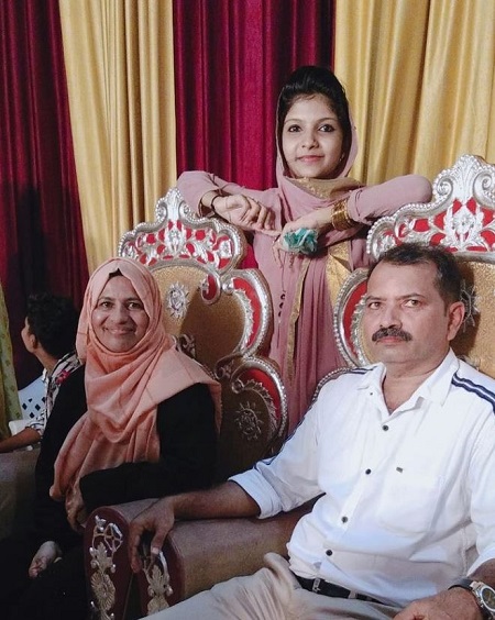 Rifa Mehnu with her mother and father