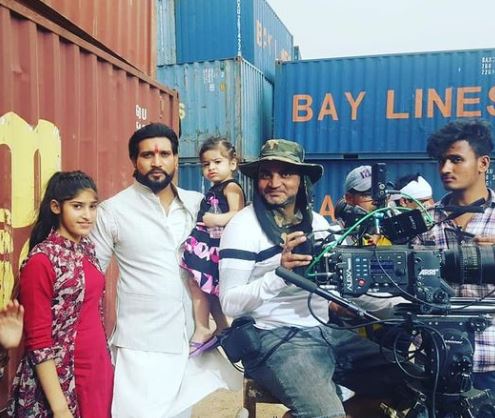 John and his daughters on the film set