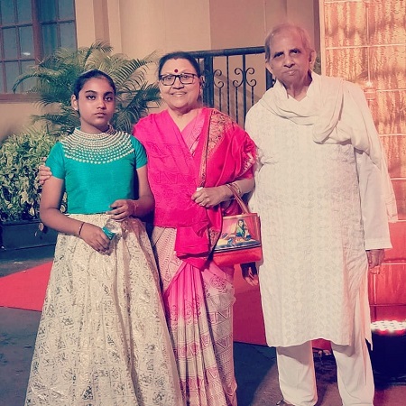 Maya Govind with her grand daughter and husband