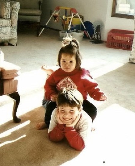 Anisa Jomha playing with her brother