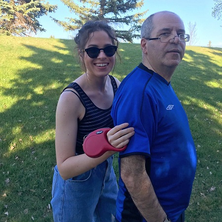 Anisa Jomha standing with her father