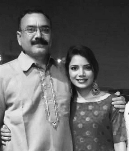 Palak Singh standing with her father