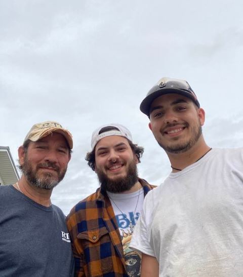 Lane Fernandez with his brother and father