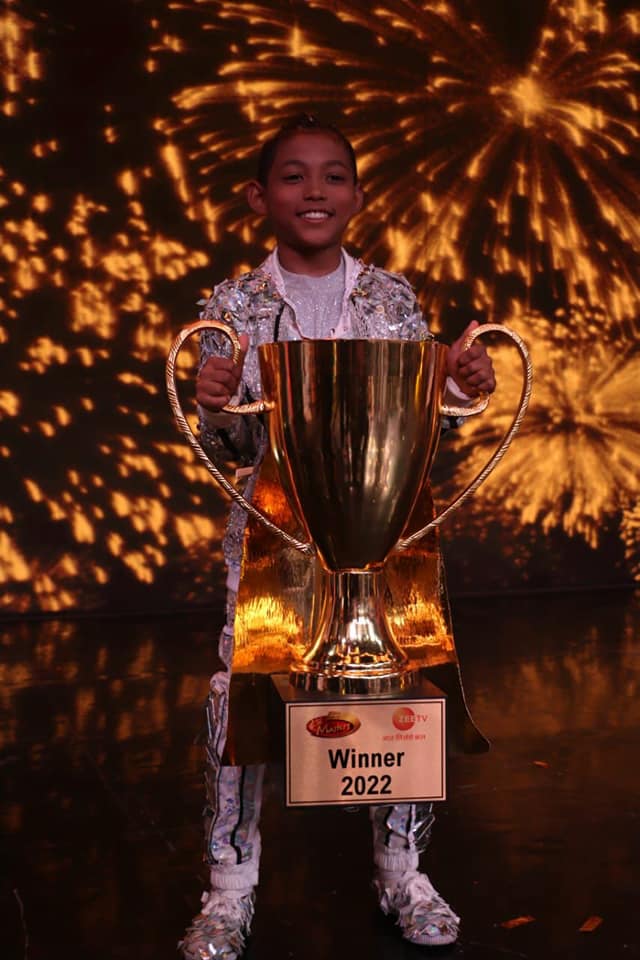Nobojit Narzary holding the winner trophy