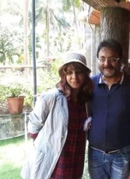 Keya Pothen standing with her father