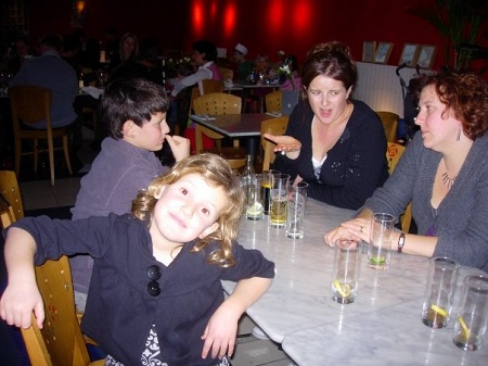 Susie Steiner sitting in black dress with her family members