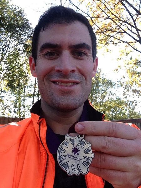 Zafar Rushdie showing his half marthon medal