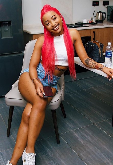 Uncle Waffles inked tattoos on her arm and waist