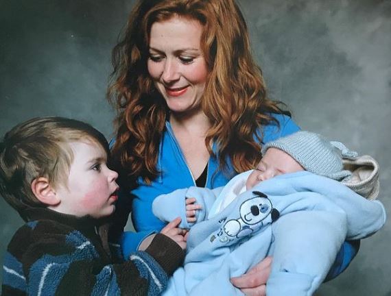 Childhood photo of Elliot with his mom and brother