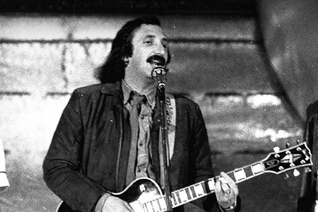 Franco Gatti singing and plying guitar