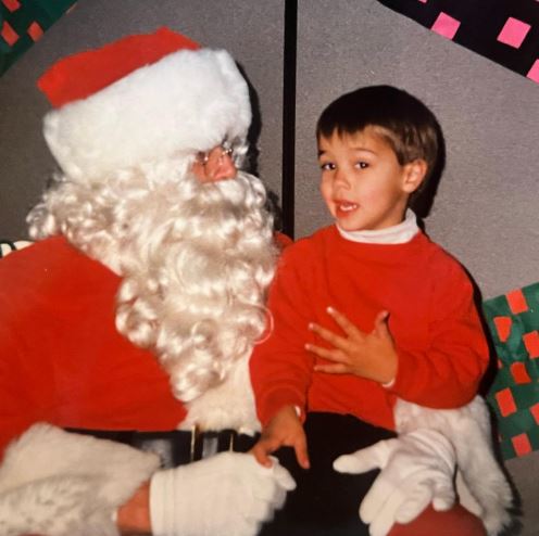 Childhood photo of Derek with Santa