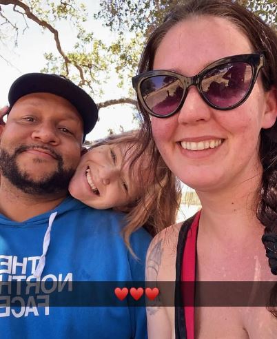 Laura with her husband and daughter