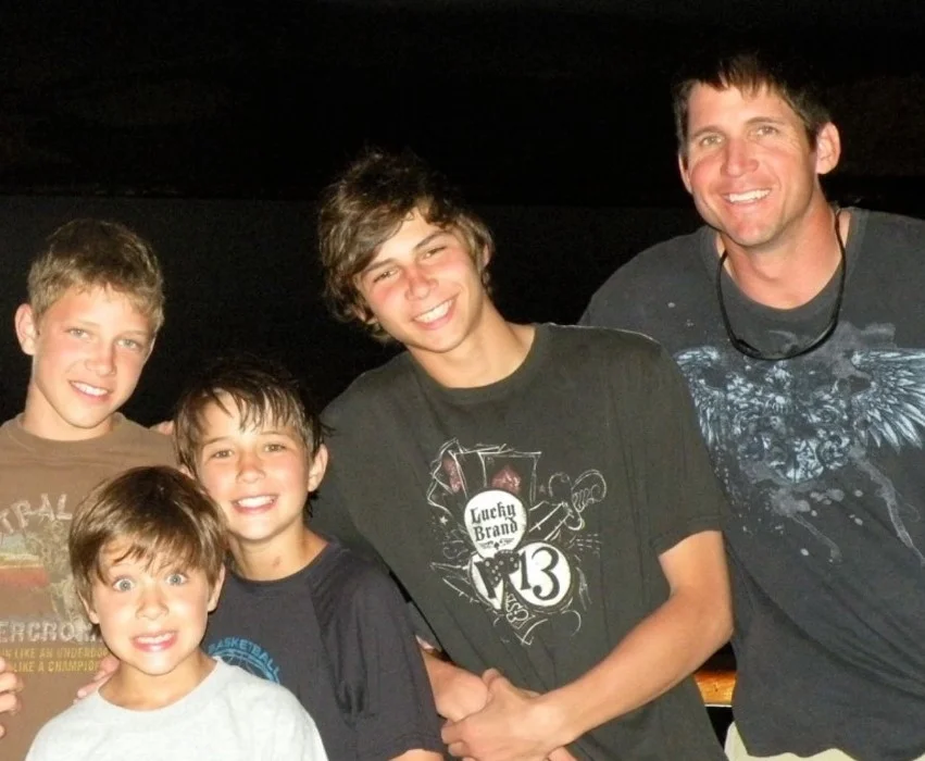 Childhood photo of Dylan with his siblings and father