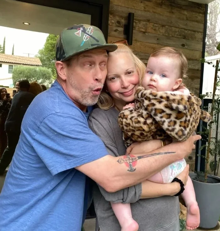 Kennya Baldwin with her husband and grandkid
