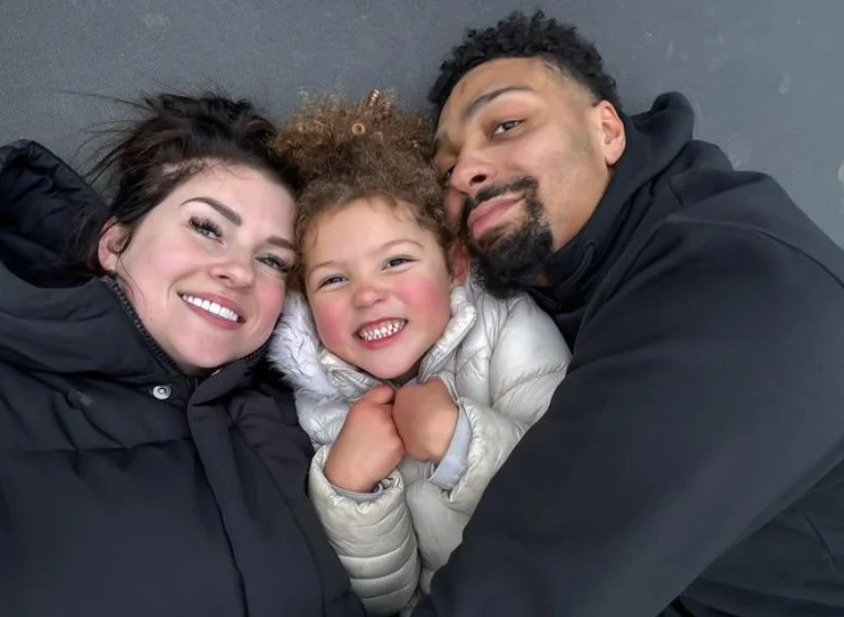 Naomi Courts with her husband and daughter